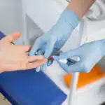 Image of medical profession performing HIV test